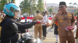 Wali Kota Cilegon, Helldy Agustian, saat membagikan bendera merah putih ke masyarakat Kota Cilegon yang melintas di depan gedung Pemkot Cilegon, Senin (7/8/2023). ISTIMEWA 
